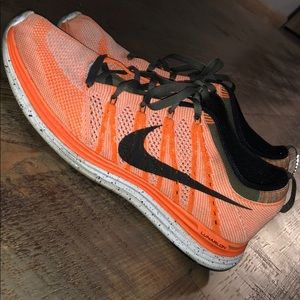 Orange and black nike shoes